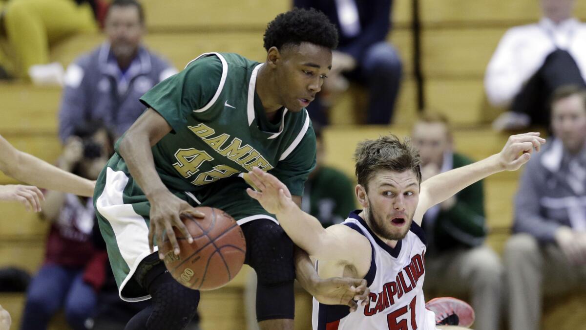 Damien's Jeremy Hemsley, left, battles for loose ball with Campolindo's Sean Smith during Damien's victory in the CIF Division III championship game in Berkeley on March 27.