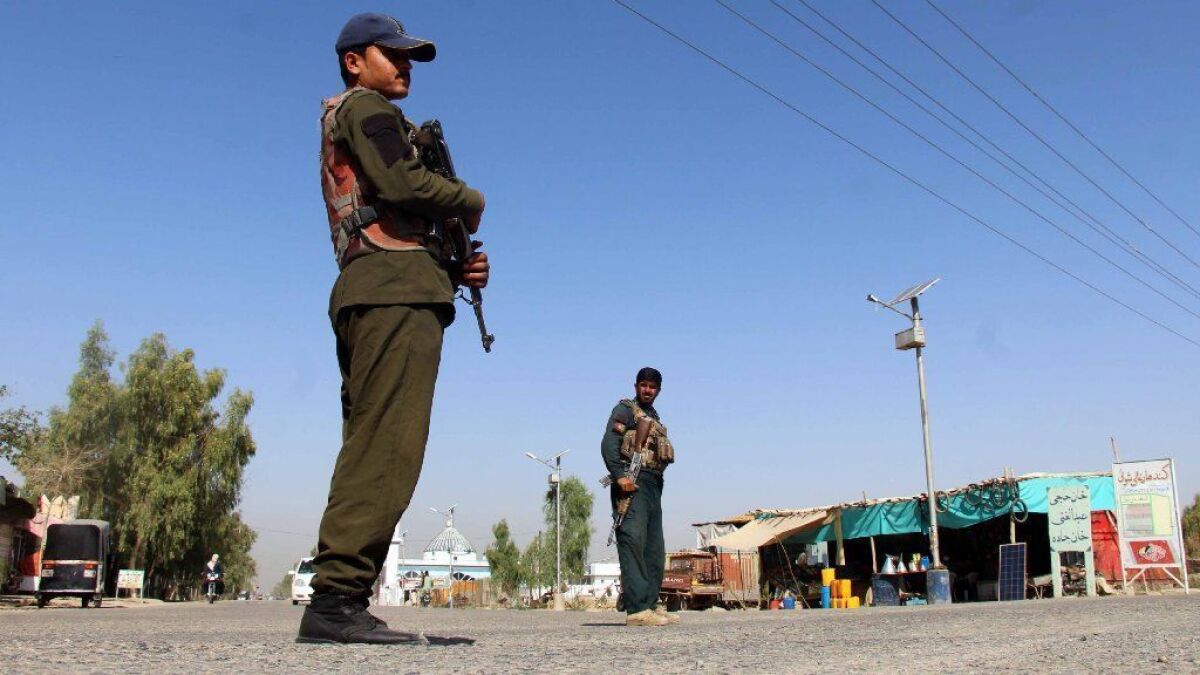 Afghan security personnel guard a checkpoint in Kandahar, Afghanistan.