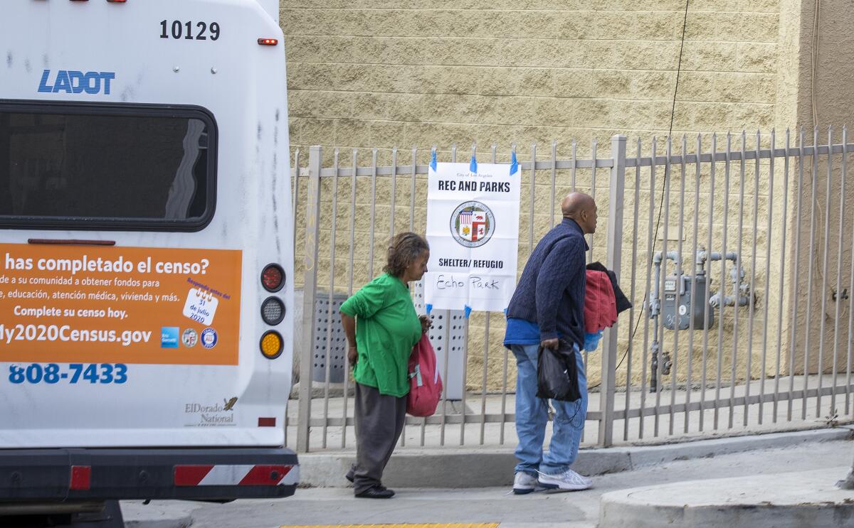 Homeless people from skid row and other areas arrive via bus at the Echo Park Community Center