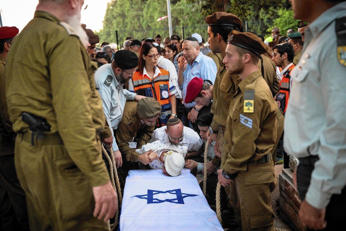 The grandmother of Israeli soldier Jordan Bensimon cries over his casket Tuesday.