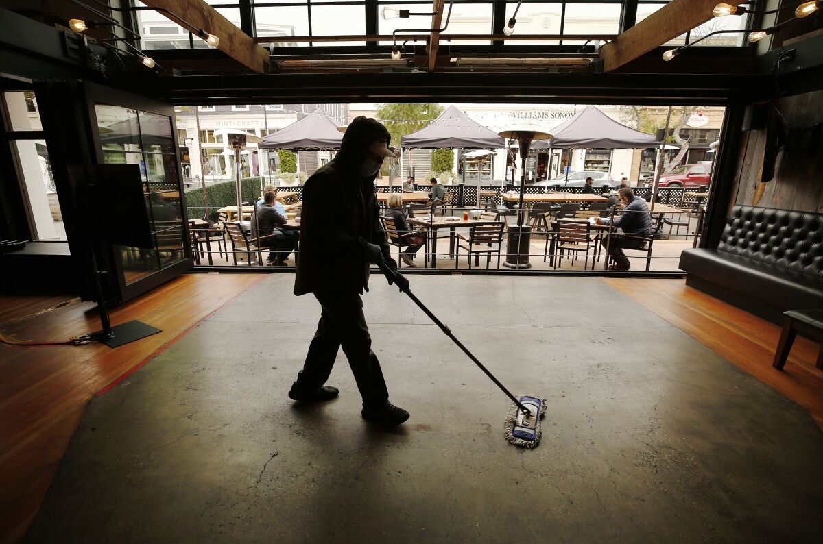 Andy Grant cleans Finney's Crafthouse & Kitchen in downtown San Luis Obispo.