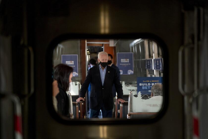 Democratic presidential candidate former Vice President Joe Biden speaks with United Steelworkers Union President Thomas Conway and school teacher Denny Flora of New Castle, Pa., aboard his train as it travels to Pittsburgh, Wednesday, Sept. 30, 2020. (AP Photo/Andrew Harnik)