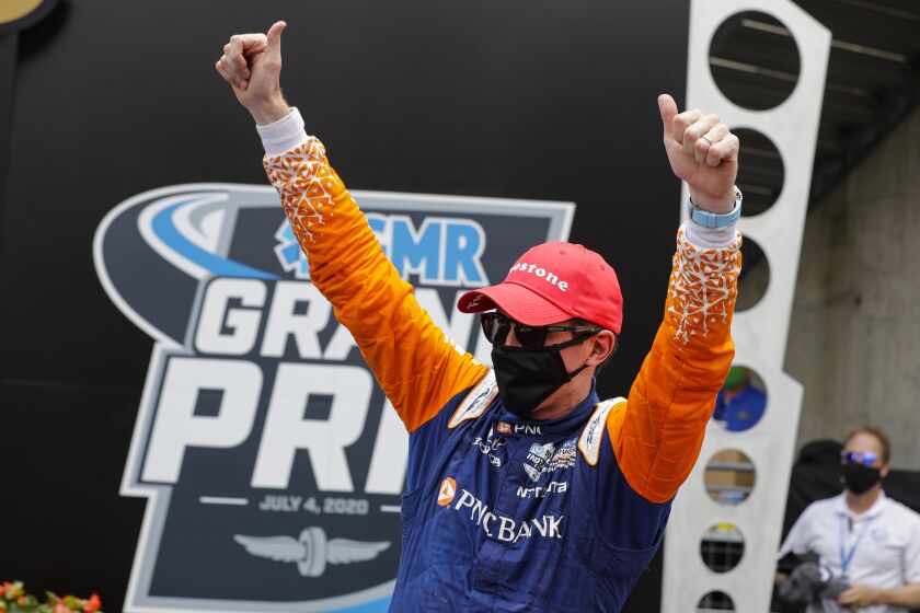 Race driver Scott Dixon, of New Zealand, celebrates after winning the IndyCar auto race at Indianapolis Motor Speedway in Indianapolis, Saturday, July 4, 2020. (AP Photo/Darron Cummings)