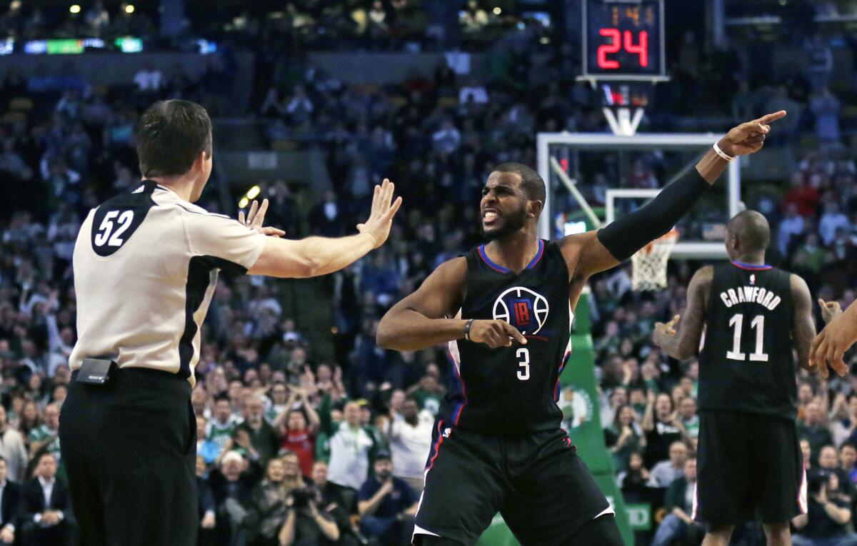 Clippers guard Chris Paul argues a call with referee Scott Twardoski during overtime against Boston on Wednesday night.