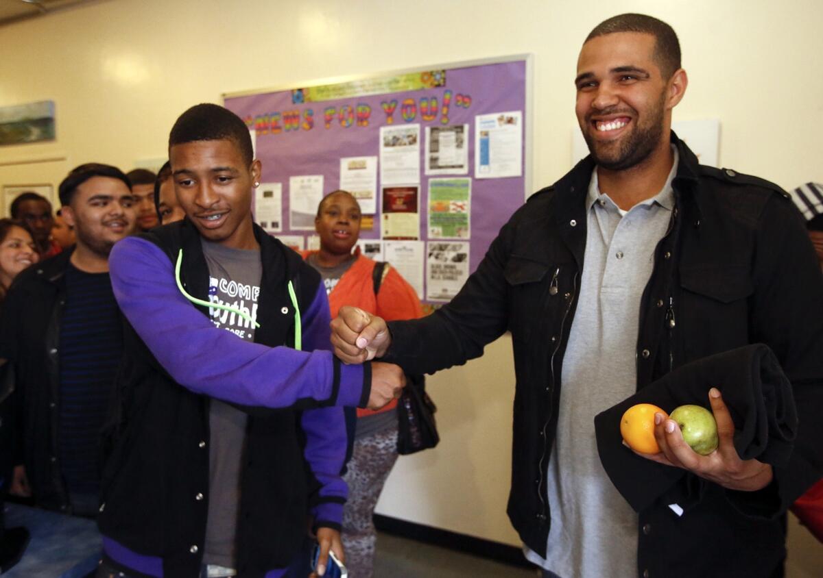 Prophet Walker, right, greets Deandre Harper, 17, after speaking to students at Compton YouthBuild. "The most heartbreaking thing to me is to see children in this area who have been stripped of their right simply to dream," Walker said.