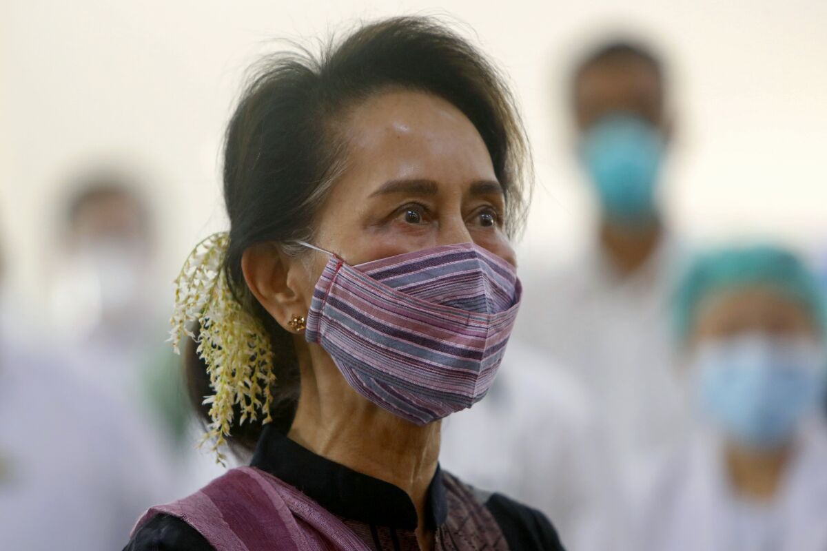 FILE - Then Myanmar leader Aung San Suu Kyi watches the vaccination of health workers at hospital in Naypyitaw, Myanmar on Jan. 27, 2021. Myanmar’s state election commission has announced it is prosecuting the country’s ousted leader, Aung San Suu Kyi, and more than a dozen other top political figures for alleged fraud in last November’s general election. The announcement was published Tuesday, Nov. 16, 2021, in a notice in the state-run Global New Light of Myanmar newspaper and other official media (AP Photo/Aung Shine Oo, File)