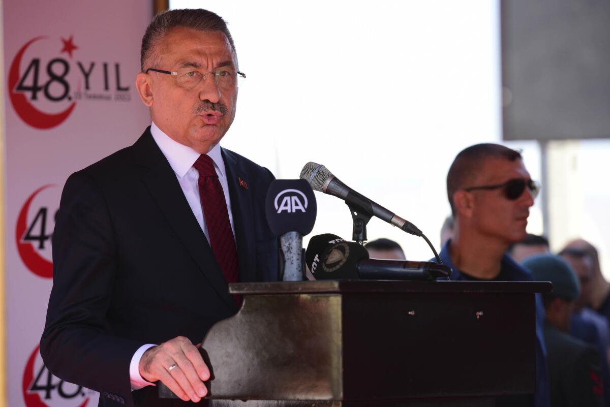 Vice President of Turkey Fuat Oktay talks during a military parade marking the 48th anniversary of the 1974 Turkish invasion in the Turkish occupied area of the divided capital Nicosia, Cyprus, Wednesday, July 20, 2022. Cyprus was split into Greek Cypriot south and Turkish Cypriot north in 1974 when Turkey invaded in response to a coup by supporters of a union with Greece. (AP Photo/Nedim Enginsoy)