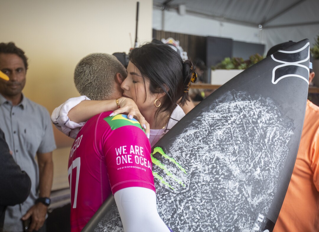 Filipe Toledo is hugged by his wife, Ananda Marcal, before his match Gabriel Medina