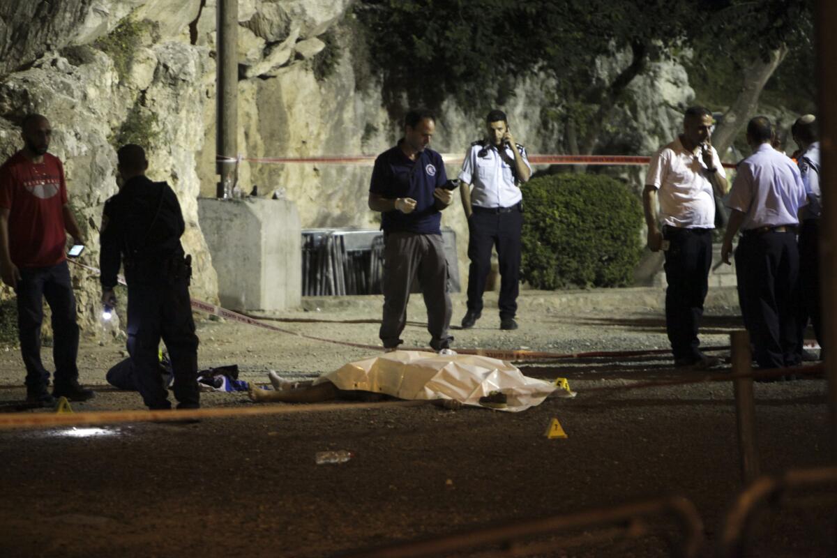 Israeli police work around the body of a Palestinian in Jerusalem on June 17. The man was one of three Palestinians who authorities said attacked Israeli officers near Jerusalem's Old City.