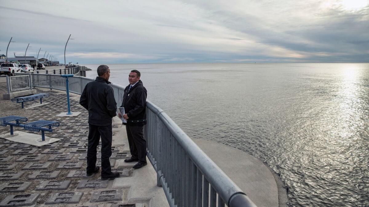 President Obama, left, gets a tour of Kotzebue Shore Avenue, which has dealt with erosion problems, in Kotzebue, Alaska, in 2015.