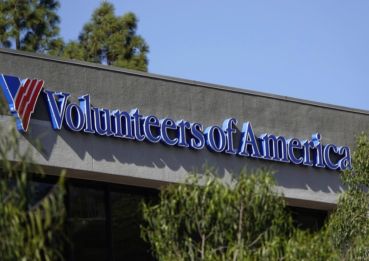 A close-up of the "Volunteers of America" logo on a building