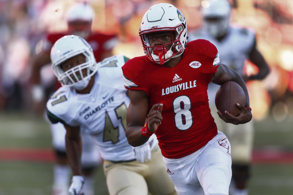 Louisville quarterback Lamar Jackson (8) runs the ball for a touchdown as Charlotte defensive back AJ McDonald (41) follows at Papa John's Cardinal Stadium.