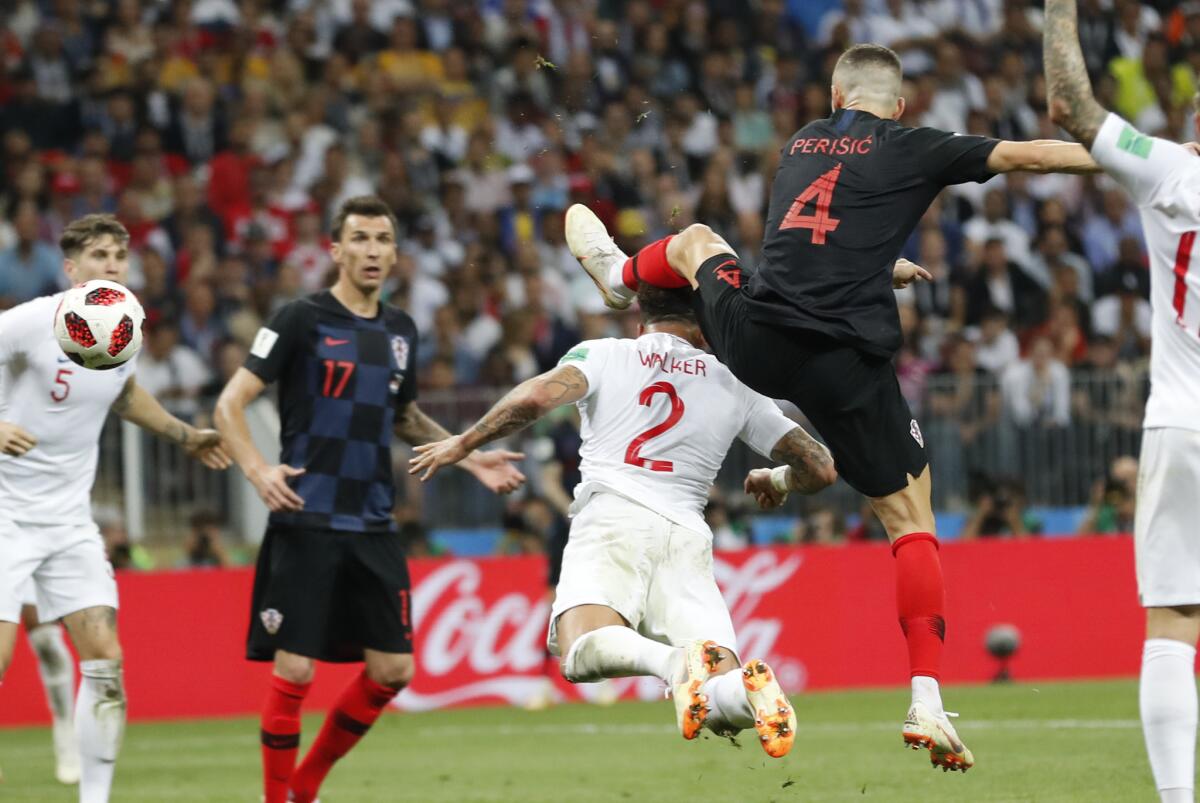 Croatia's Ivan Perisic, right, scores his side's opening goal during the semifinal match between Croatia and England at the 2018 soccer World Cup in the Luzhniki Stadium in Moscow, Russia, Wednesday, July 11, 2018.