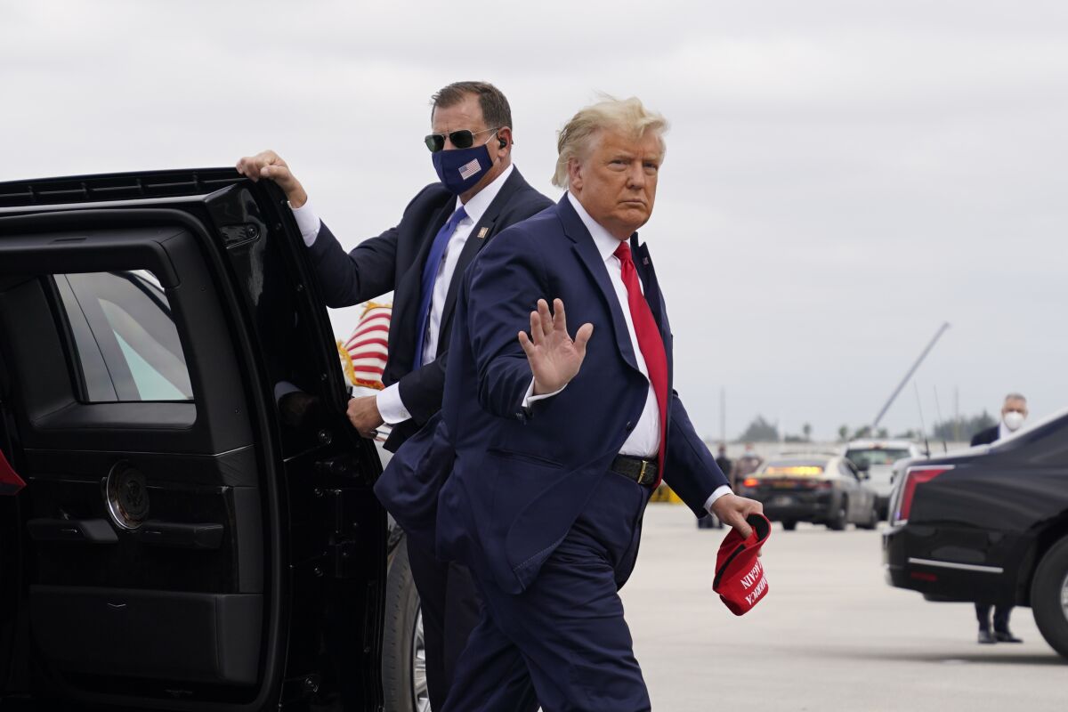 President Donald Trump arrives to board Air Force One for a day of campaign rallies, Monday, Nov. 2, 2020, in Miami. (AP Photo/Evan Vucci)
