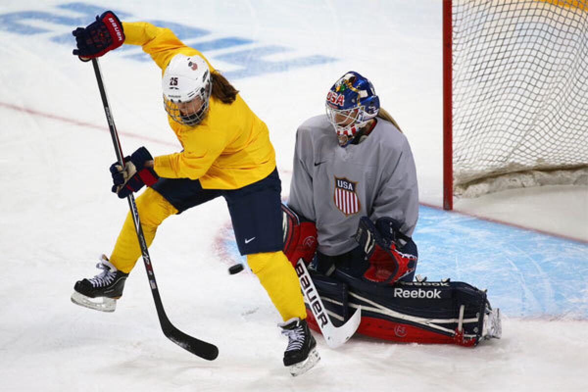 U.S. women's hockey player Alex Carpenter takes a shot against teammate Brianne McLaughlin during a training session Monday at Shayba Arena ahead of the Sochi 2014 Winter Olympics.