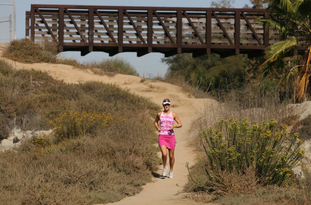 A woman runs on a trail in Newport Beach's Back Bay in 2008.