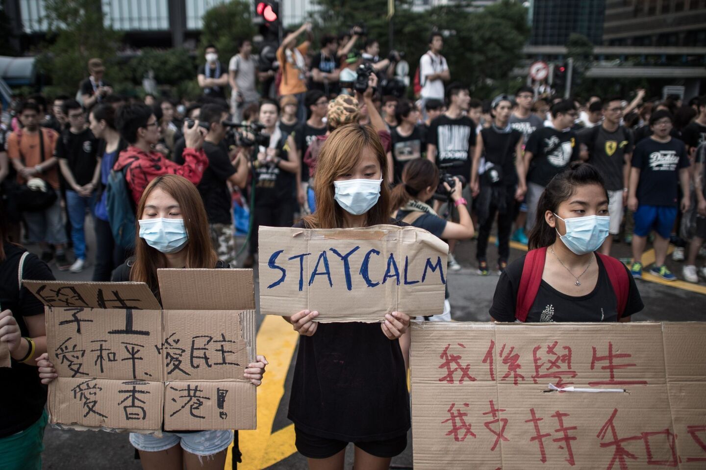 Pro-democracy demonstrators display placards as they gather near a ceremony marking China's 65th National Day in Hong Kong on Wednesday.
