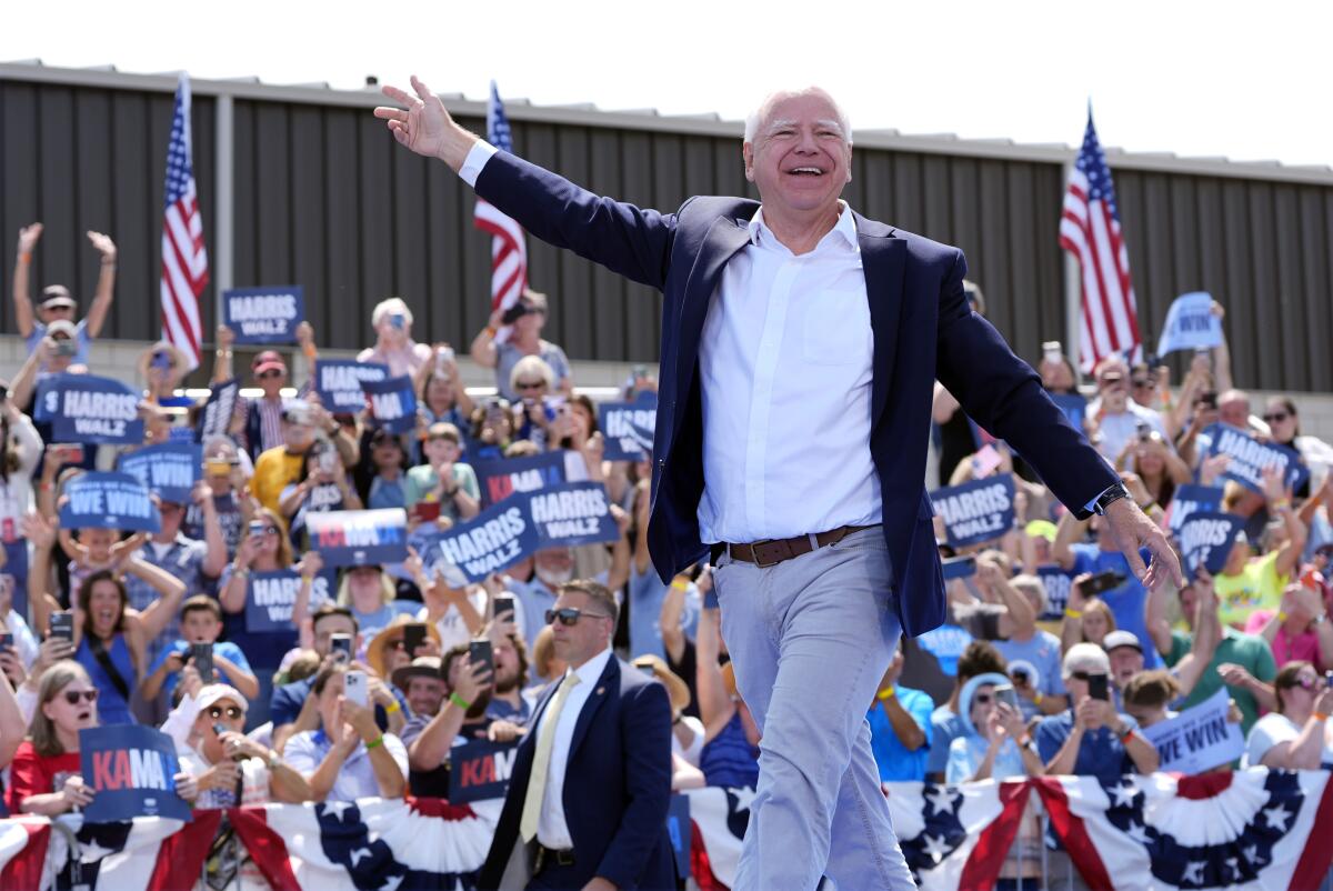 Tim Walz waves to a crowd