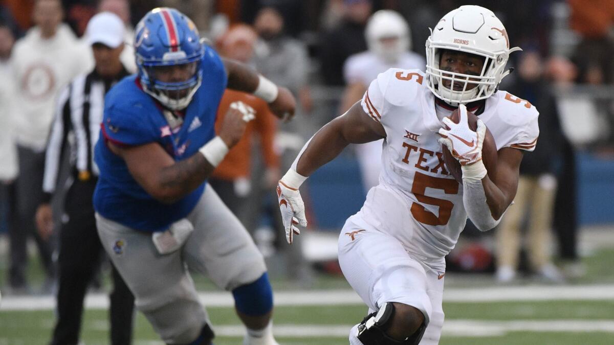 Texas running back Tre Watson picks up a first down against Kansas on Friday.