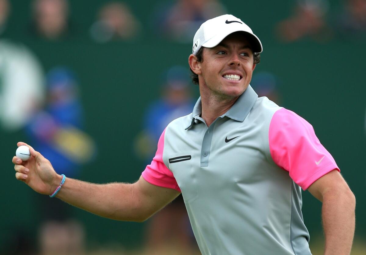 Rory McIlroy prepares to throw the ball into the crowd after finishing off his victory at the 143rd Open Championship on Sunday at Royal Liverpool.