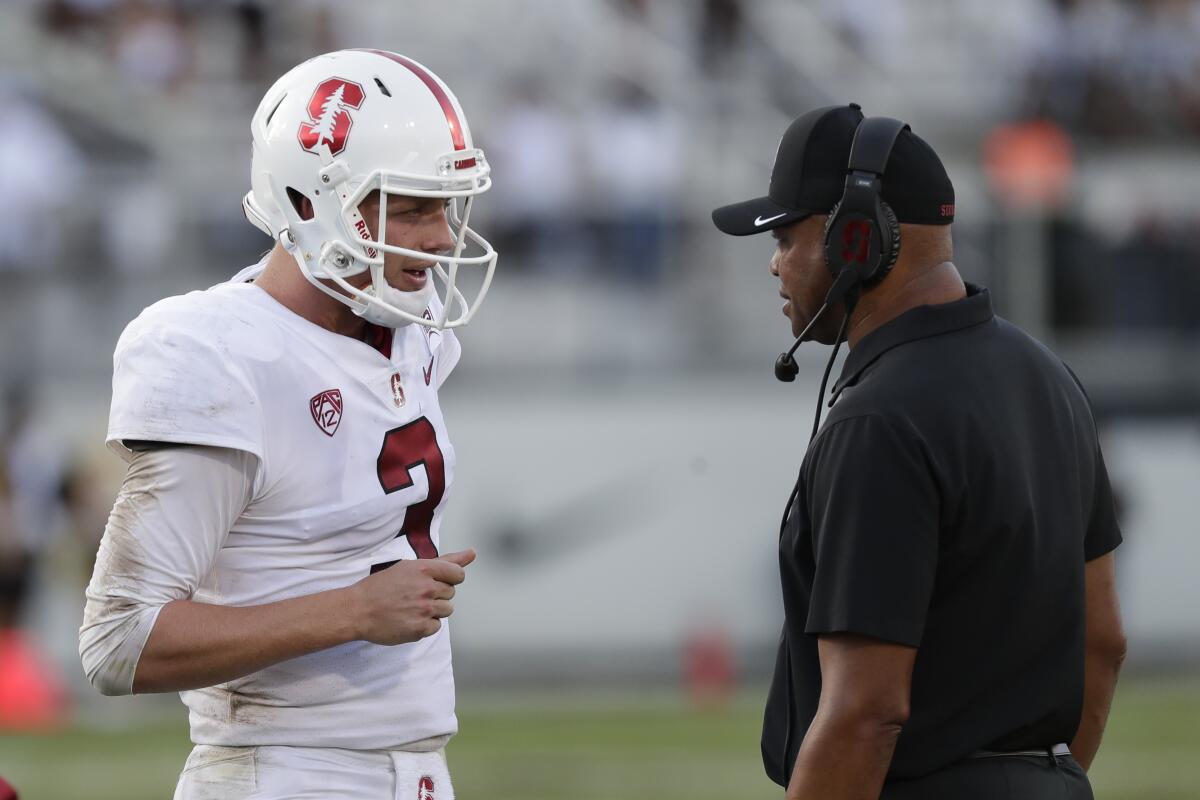 Stanford quarterback K.J. Costello, left, talks with coach David Shaw during Saturday's loss to Central Florida.