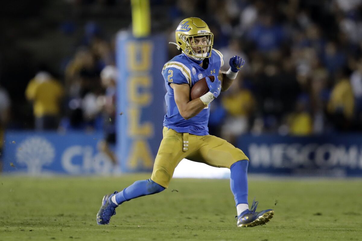UCLA wide receiver Kyle Philips runs after making a catch against Arizona State in 2019.