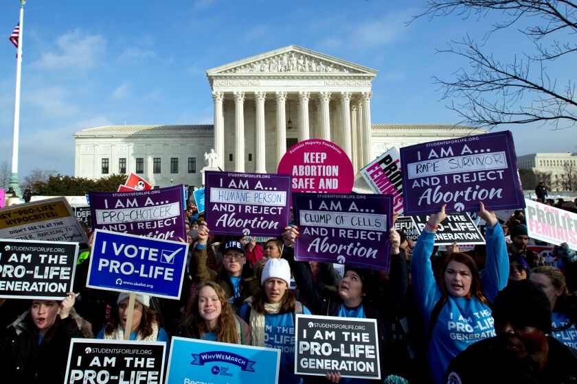 FILE - In this Jan. 18, 2019, file photo, anti-abortion activists protest outside of the U.S. Supreme Court during the March for Life in Washington. Anti-abortion activists will gather in Washington on Friday, Jan. 24, 2020, for the annual march, eager to cheer on a continuing wave of federal and state abortion restrictions. (AP Photo/Jose Luis Magana, File)