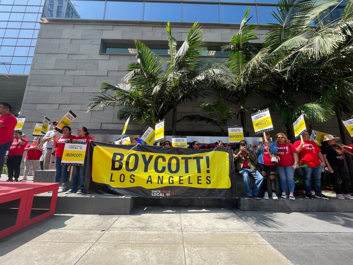 Los Angeles, California-Aug. 24, 2023-Hotel workers represented by Unite Here Local 11 picketed outside the JW Marriott Hotel in downtown Los Angeles on Thursday morning, Aug. 24, 2023. After several tense and sometimes violent incidents on hotel picket lines, the union on Thursday calling for a boycott of hotels who have not yet reached a contract. (Suhauna Hussain/Los Angeles Times)