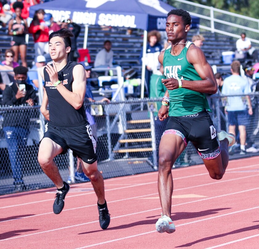 Dijon Stanley of Granada Hills (right) goes past Jaden Rattay of Lincoln to win the 400 in 46.94,