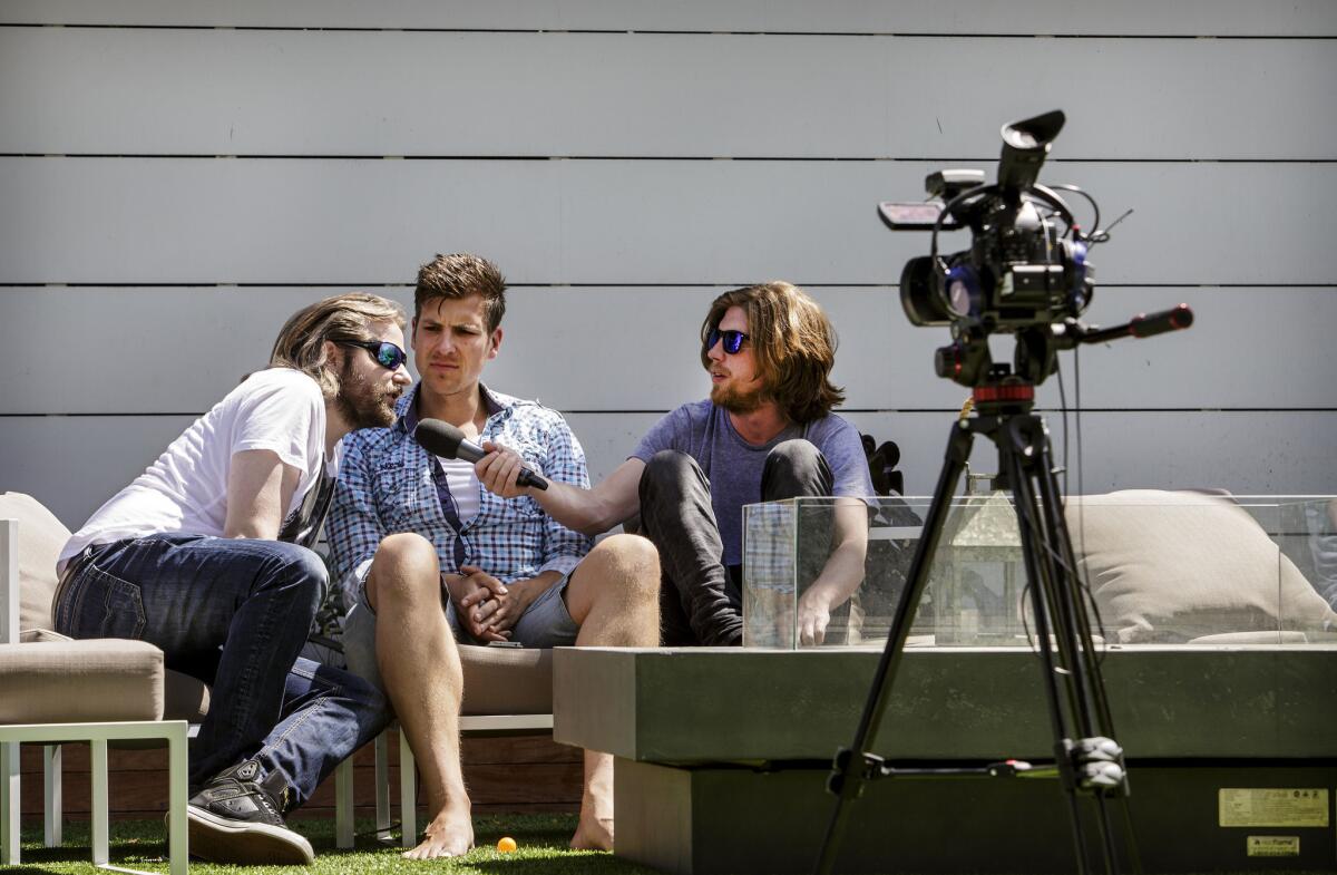 Erik "Gronkh" Range, left, David Hain and Valentin “Sarazar” Rahmel record in the backyard of a West Hollywood home.