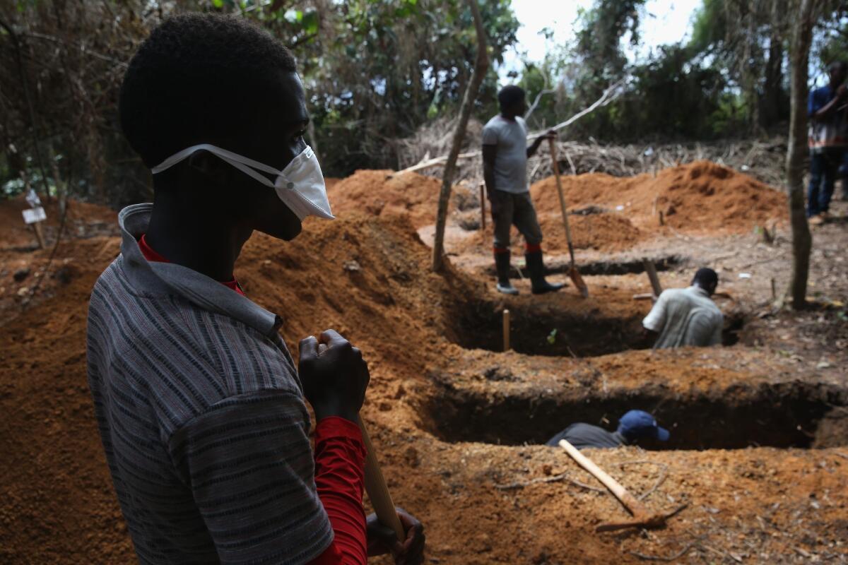 Grave diggers prepare for new Ebola victims outside a treatment center near Gbarnga in central Liberia on Oct. 7.