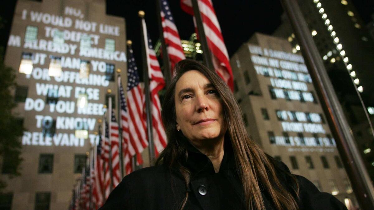 Jenny Holzer's "For the City" is projected in front of two of the three buildings at Rockefeller Center in New York.