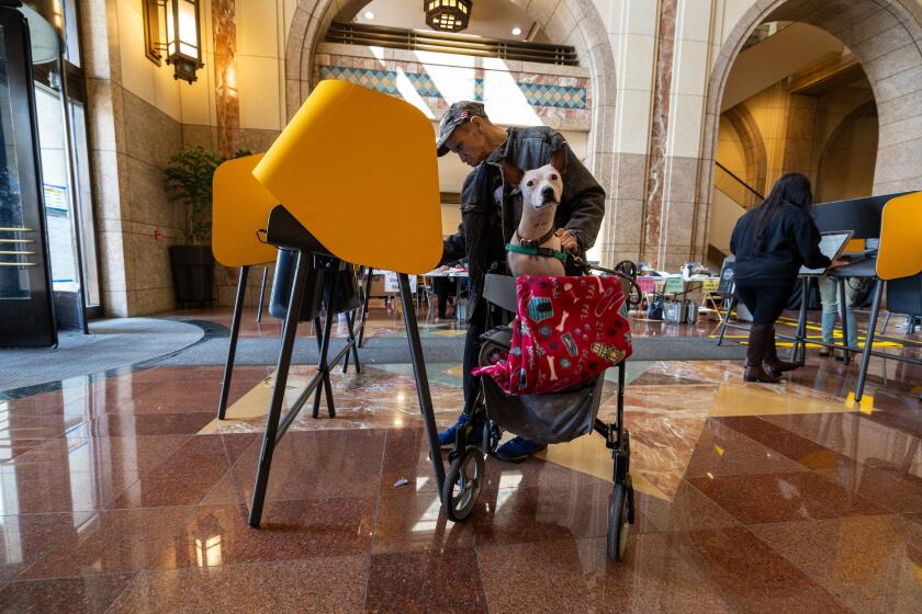 Los Angeles, CA - March 05: Voters cast their ballots inside the cavernous lobby of the Metro Headquarters Building on Tuesday, March 5, 2024 in Los Angeles, CA. (Brian van der Brug / Los Angeles Times)