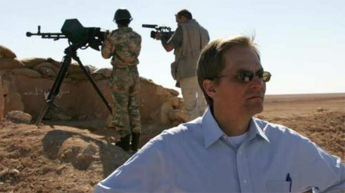 DELEGATE SITUATION: An unidentified U.S. diplomat, foreground, visits a military border post in the desert between Syria and Iraq.