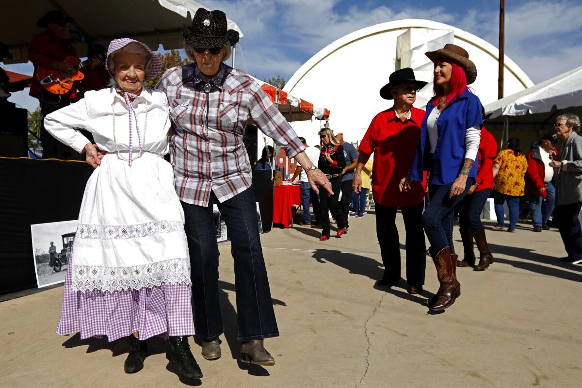 Couples including a woman in period dress dance at Dust Bowl Festival