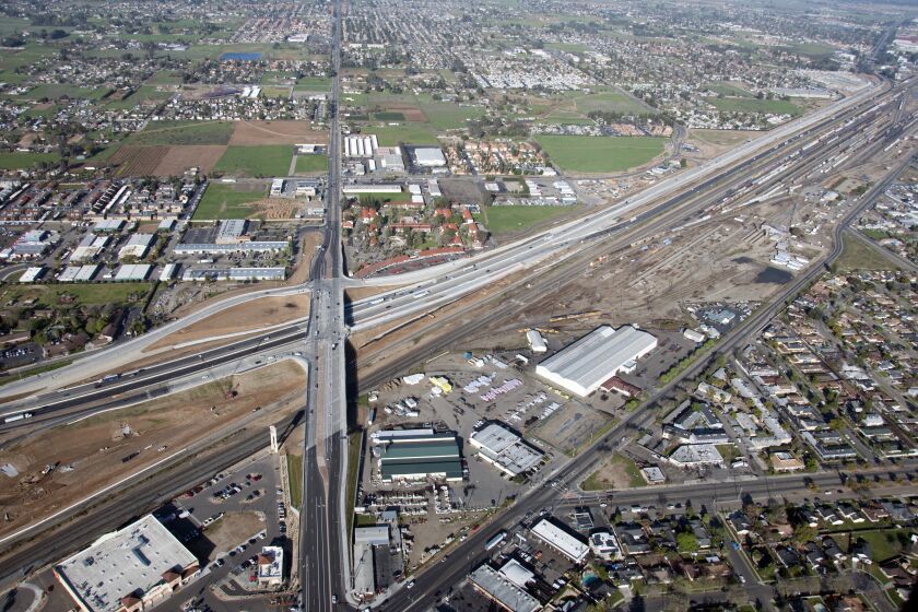 California's bullet train project has struggled to acquire all the parcels it needs for the high-speed rail line, which involves relocating numerous, utilities, roads and other infrastructure. This aerial photo shows the State Route 99 realignment in central Fresno during March of 2018.