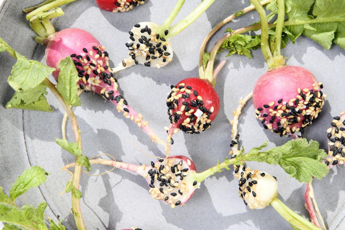 Coconut oil helps sesame seeds cling to crisp radishes.