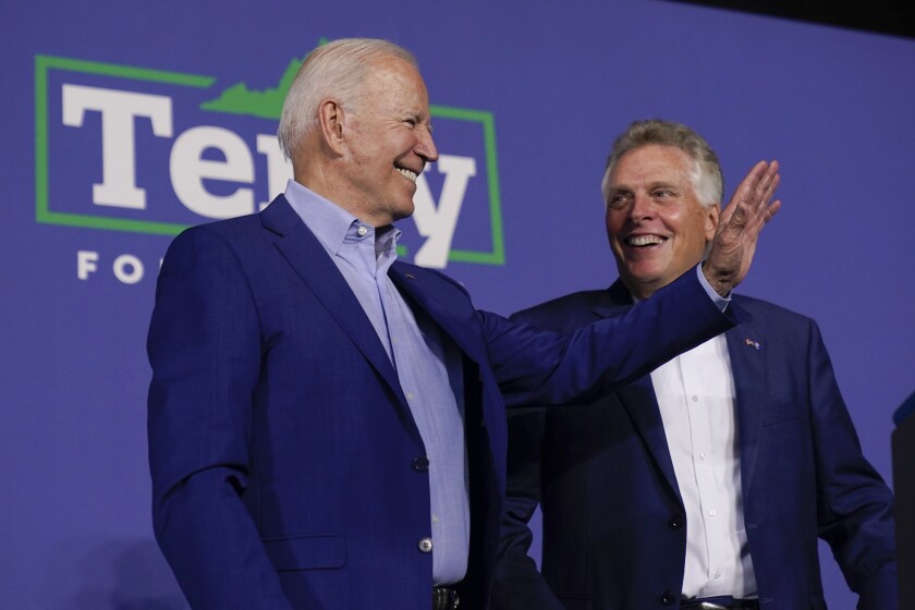 President Biden waves from the stage during a Virginia campaign event with Terry McAuliffe.