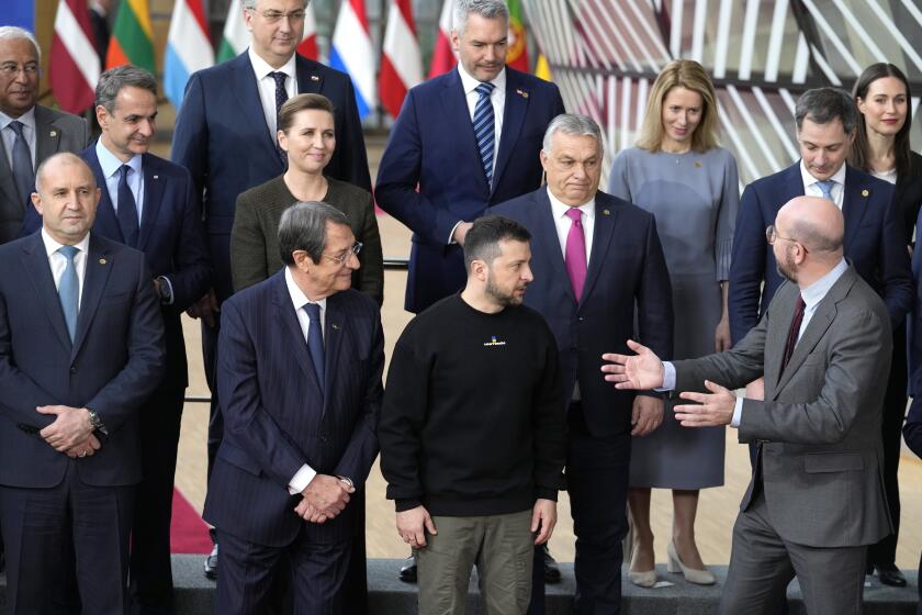FILE - European Council President Charles Michel, front right, speaks with Ukraine's President Volodymyr Zelenskyy, front second right, and Hungary's Prime Minister Viktor Orban, second row center, as they pose with other European Union leaders for a group photo at an EU summit in Brussels on Thursday, Feb. 9, 2023. The European Union decided Thursday, Dec. 14, 2023 to open accession negotiations with Ukraine, a stunning reversal for a country at war that had struggled to find the necessary backing for its membership aspirations and long faced opposition from Hungarian Prime Minister Viktor Orban. (AP Photo/Virginia Mayo, File)