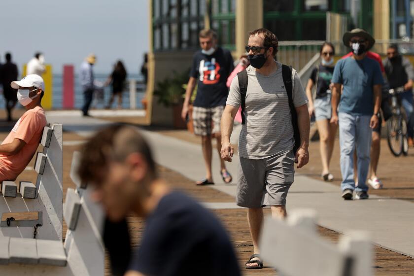 SANTA MONICA-CA-JULY 21, 2020: People visit the Santa Monica Pier on Tuesday, July 21, 2020. California has again reported its highest number of coronavirus cases in a single day Monday. (Christina House / Los Angeles Times)