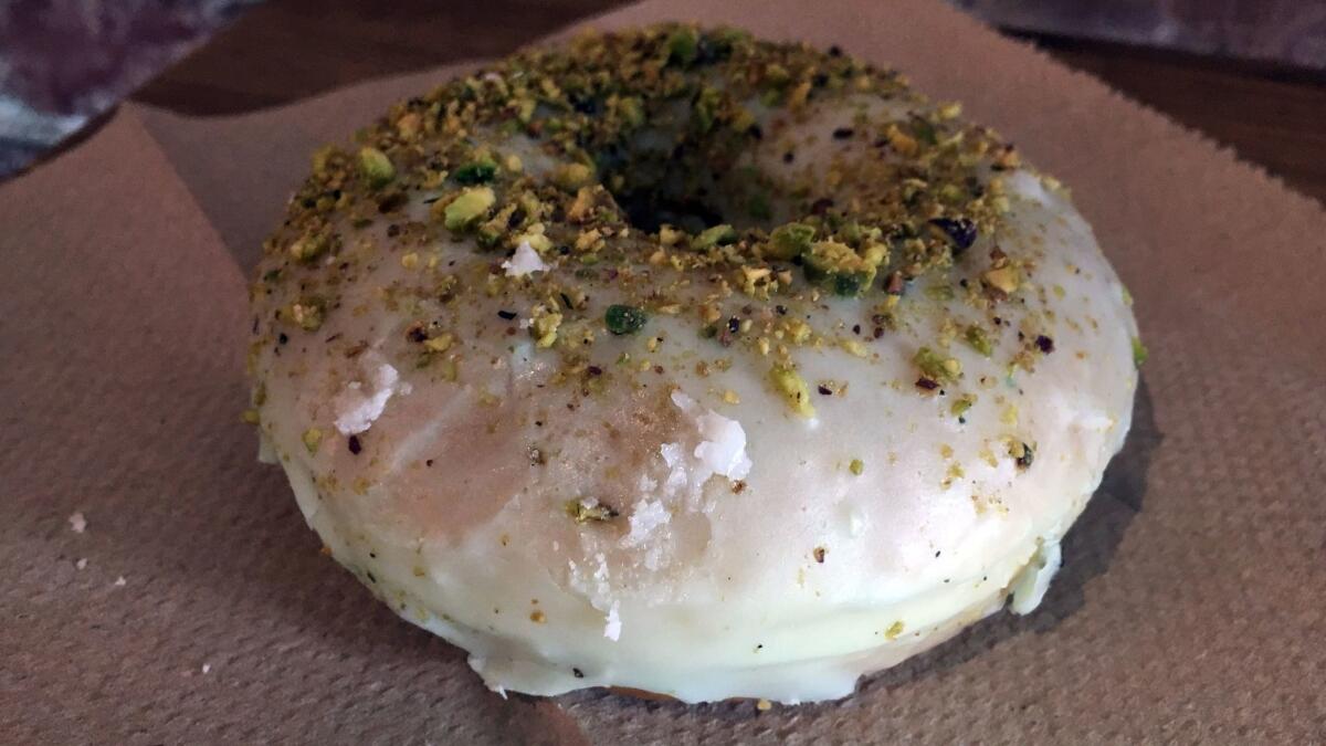 Lemon thyme pistachio doughnut from Birdies. (Jenn Harris / Los Angeles Times)