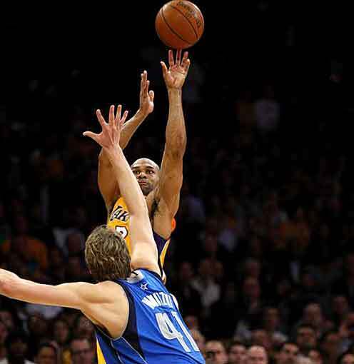 Lakers guard Derek Fisher releases the game-winning shot over Mavericks forward Dirk Nowitzki on Monday night at Staples Center.