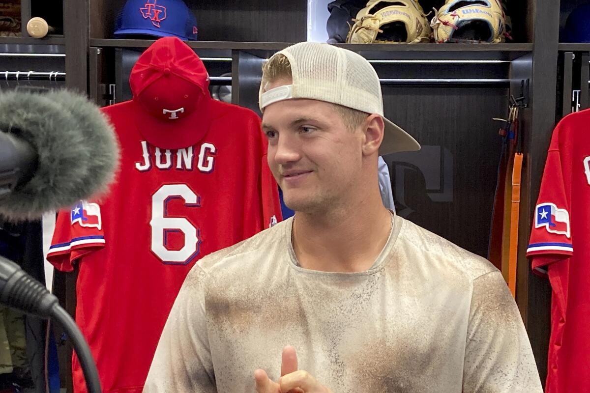Texas Rangers top prospect Josh Jung talks with reporters in front of his locker in the team's clubhouse in Arlington, Texas, Thursday, Sept. 8, 2022. Jung is expected to make his big league debut Friday night at home against the Toronto Blue Jays. (AP Photo/Stephen Hawkins)