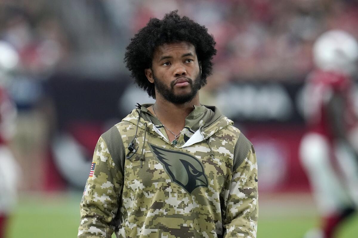 An injured Arizona Cardinals quarterback Kyler Murray paces the sidelines during the first half of an NFL football game against the Carolina Panthers Sunday, Nov. 14, 2021, in Glendale, Ariz. (AP Photo/Darryl Webb)
