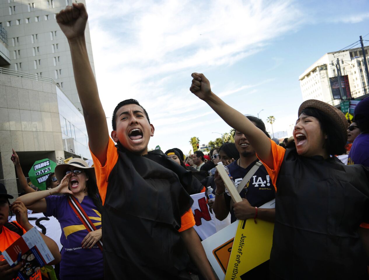 Jose Ramon Montes, left and Leticia Velez, of Children Over Politics, chant during a May Day March in downtown Los Angeles.