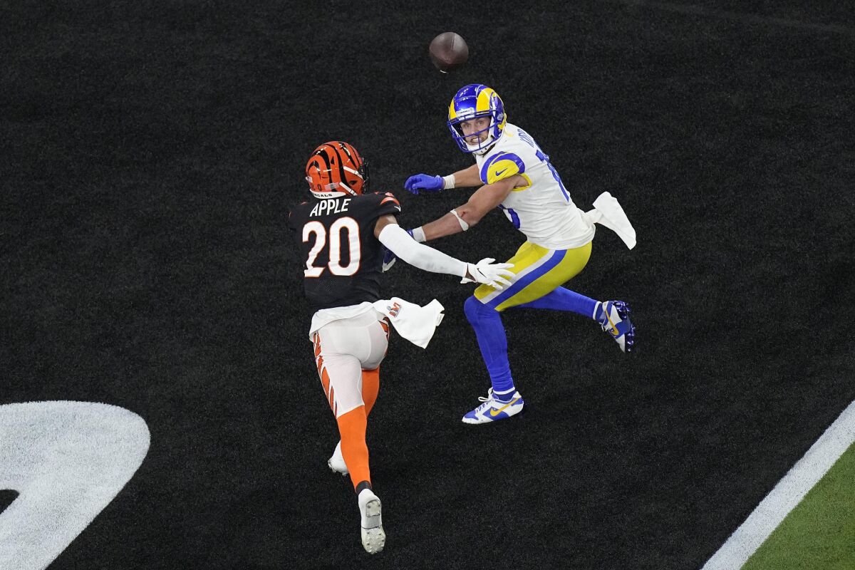 Los Angeles Rams wide receiver Cooper Kupp (10) eyes a touchdown pass in the end zone as Cincinnati Bengals cornerback Eli Apple (20) attempts to tackle during the second half of the NFL Super Bowl 56 football game, Sunday, Feb. 13, 2022, in Inglewood, Calif. (AP Photo/Matt Rourke)