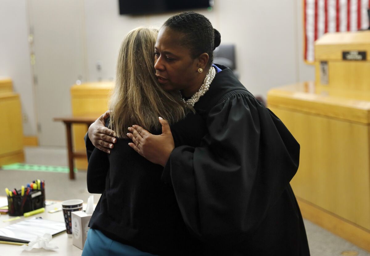 State District Judge Tammy Kemp gives former Dallas police officer Amber Guyger a hug before Guyger leaves for jail, on Wednesday in Dallas.