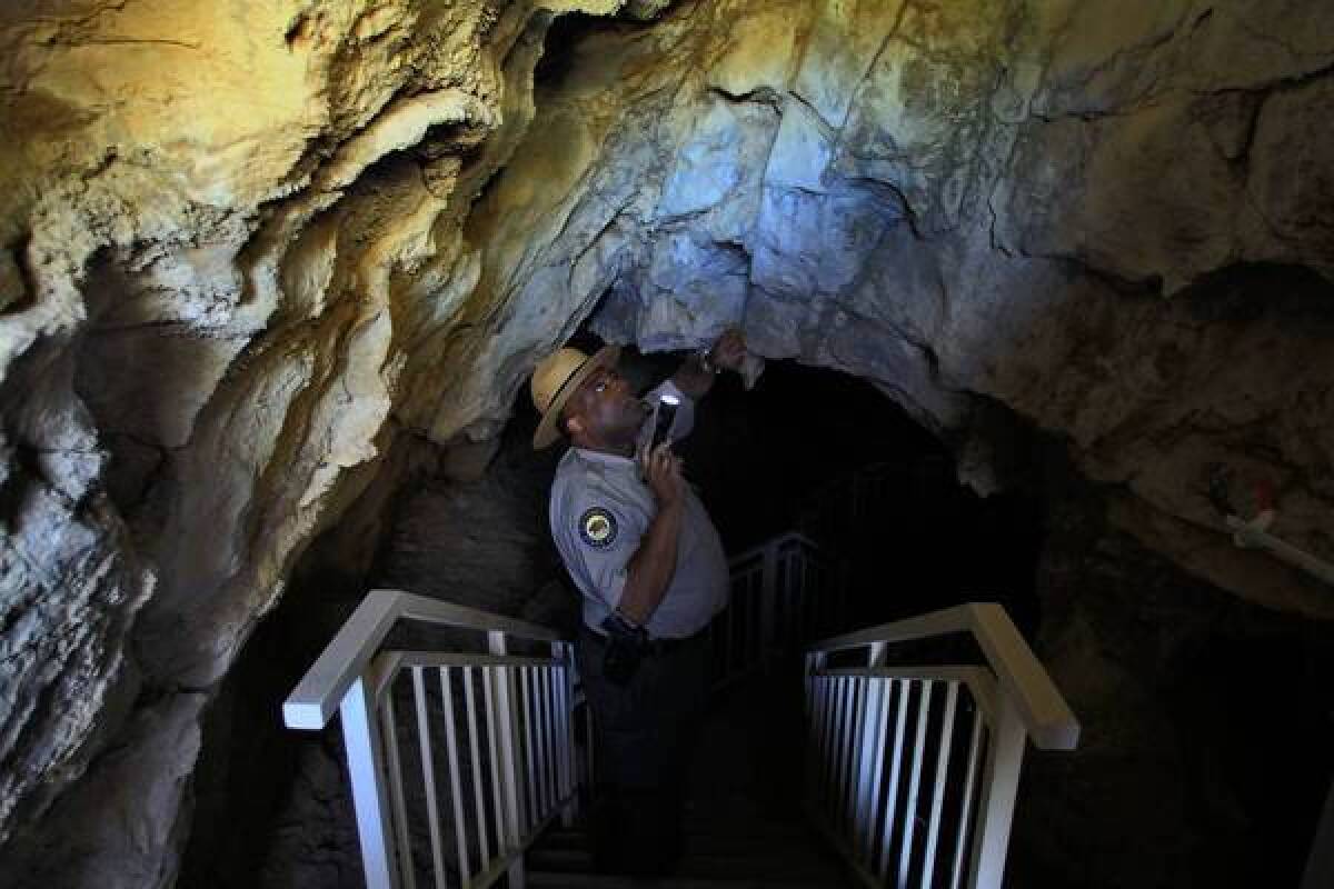 Kevin Forrester of the California Department of Parks and Recreation looks for signs of vandalism inside Mitchell Caverns at the closed Providence Mountains State Recreation Area.