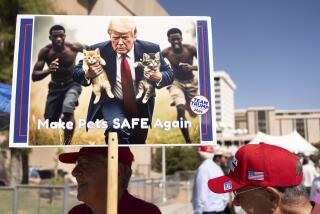 A man carries an AI-generated image of former US President and Republican presidential candidate Donald Trump carrying cats away from Haitian immigrants, a reference to falsehoods spread about Springfield, Ohio, during a campaign rally for Trump at the Tucson Music Hall in Tucson, Arizona, September 12, 2024. (Photo by Rebecca NOBLE / AFP) (Photo by REBECCA NOBLE/AFP via Getty Images)