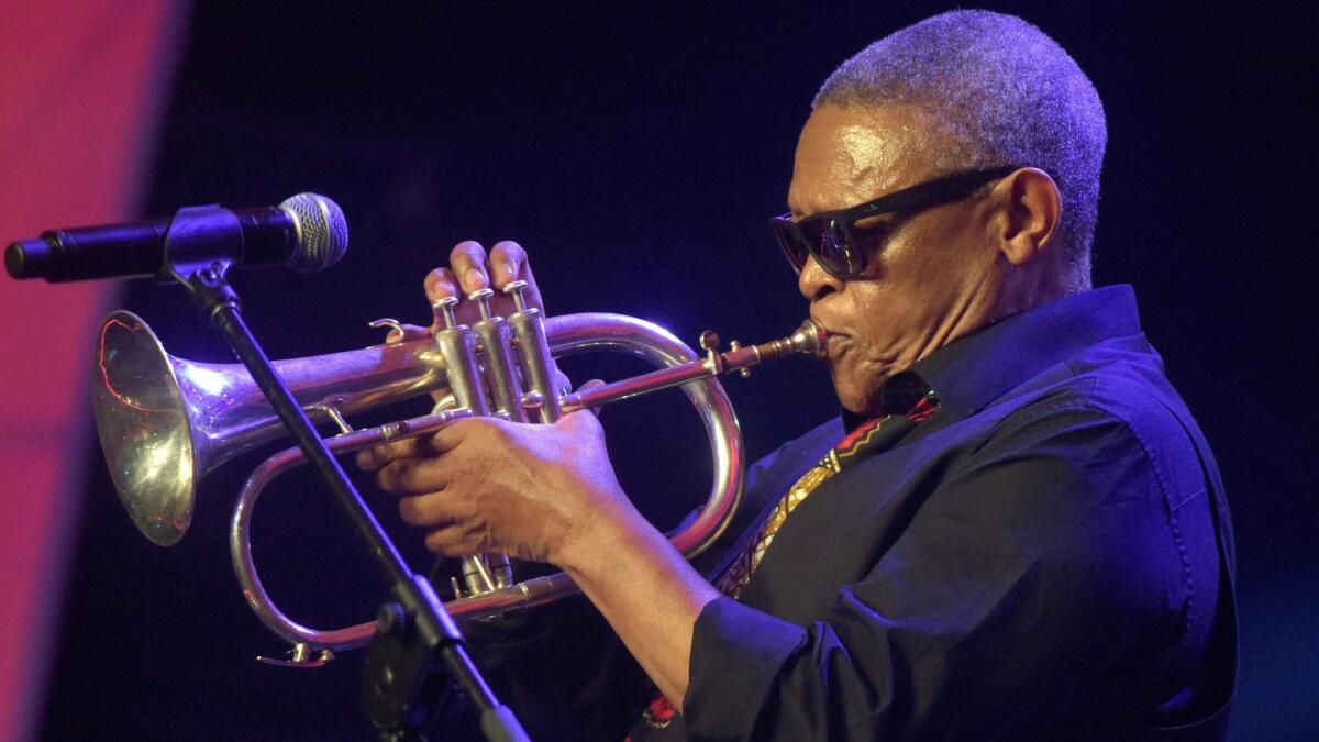 South African jazz musician Hugh Masekela plays the flugelhorn at the Confederation of African Football awards in Lagos, Nigeria, in 2015.